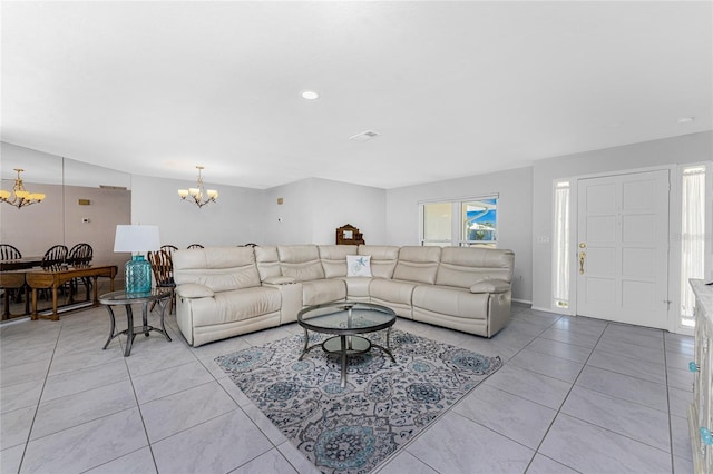 living room featuring light tile patterned flooring and a notable chandelier