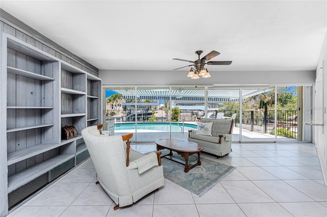 living room with a ceiling fan and a wealth of natural light