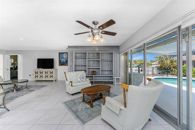 tiled living area with a ceiling fan and recessed lighting