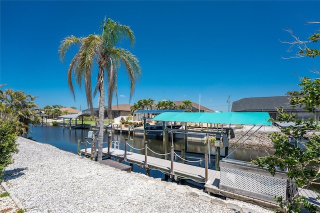 dock area with boat lift and a water view