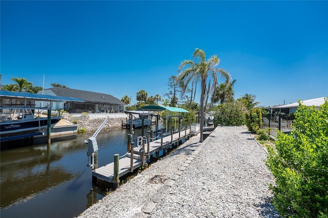 dock area featuring boat lift and a water view