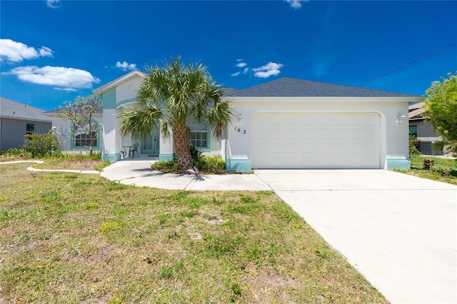 162 Fairway Rd, Rotonda West, FL 33947 - view of front of property with an attached garage, driveway, a front yard, and stucco siding