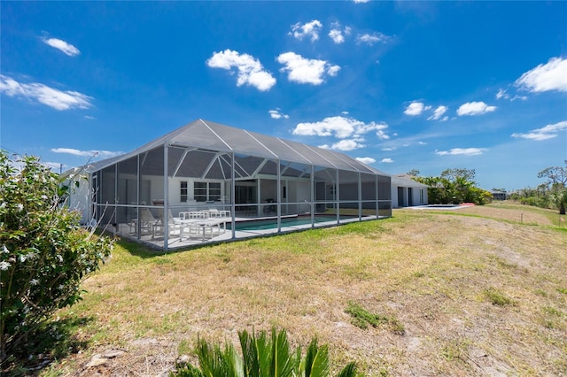 162 Fairway Rd, Rotonda West, FL 33947 - back of property featuring a yard, an outdoor pool, a patio area, and glass enclosure