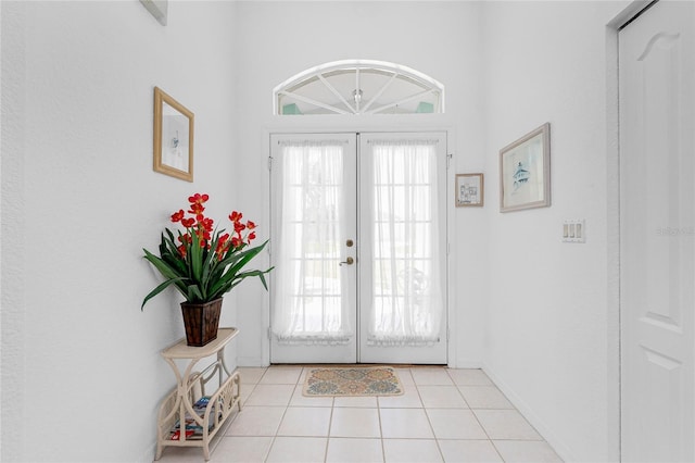 162 Fairway Rd, Rotonda West, FL 33947 - foyer entrance with light tile patterned flooring, baseboards, and french doors