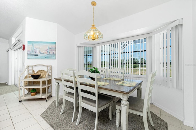 162 Fairway Rd, Rotonda West, FL 33947 - dining room featuring light tile patterned floors, baseboards, an inviting chandelier, and vaulted ceiling