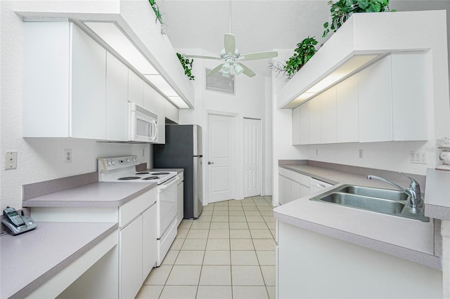 162 Fairway Rd, Rotonda West, FL 33947 - kitchen featuring light tile patterned flooring, ceiling fan, a sink, white appliances, and light countertops