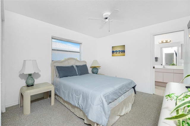162 Fairway Rd, Rotonda West, FL 33947 - bedroom featuring baseboards, a ceiling fan, ensuite bath, and light carpet