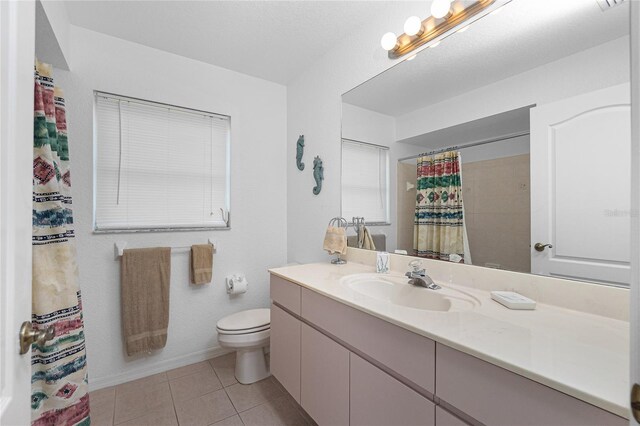 162 Fairway Rd, Rotonda West, FL 33947 - full bathroom featuring a shower with curtain, tile patterned floors, baseboards, vanity, and toilet