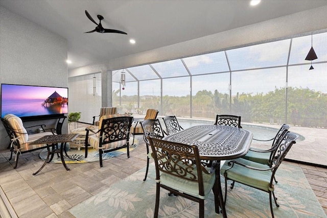 view of patio featuring ceiling fan, a lanai, and outdoor dining area