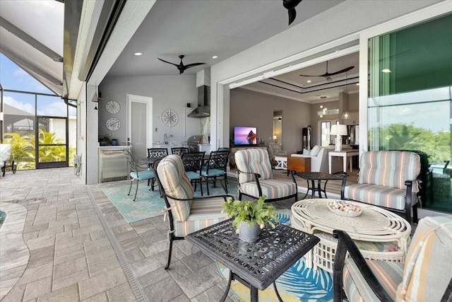 view of patio / terrace featuring a lanai, ceiling fan, area for grilling, and outdoor lounge area