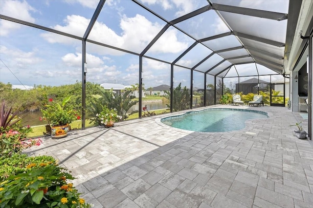 pool with glass enclosure and a patio area