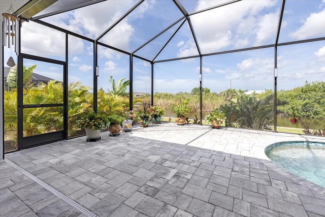 exterior space with glass enclosure and an outdoor pool