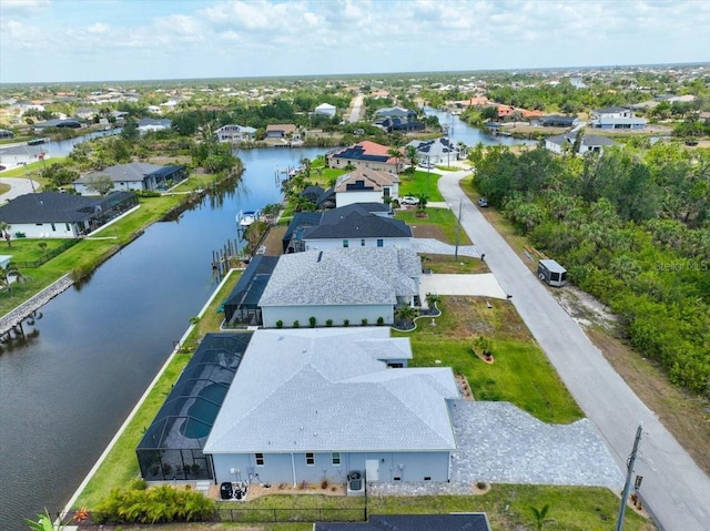 bird's eye view featuring a water view and a residential view