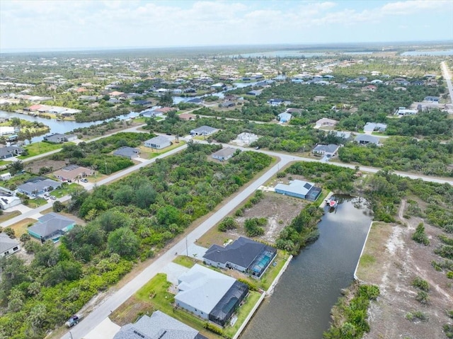 drone / aerial view featuring a water view and a residential view