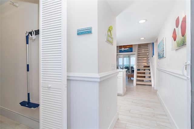 7548 Palm Island Dr S Unit 1724, Placida, FL 33946 - corridor featuring stairway, wainscoting, recessed lighting, and light wood-style flooring
