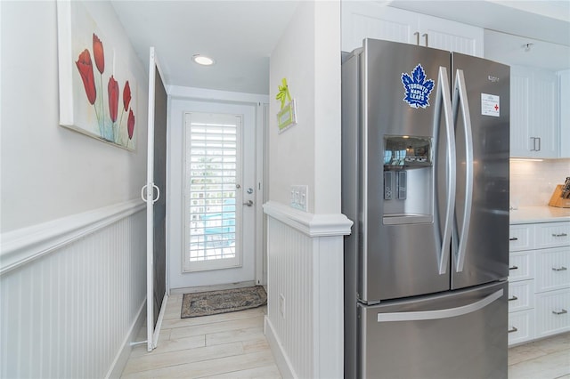 7548 Palm Island Dr S Unit 1724, Placida, FL 33946 - doorway to outside featuring recessed lighting, light wood-style flooring, a decorative wall, and a wainscoted wall