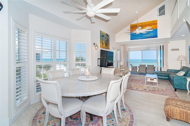7548 Palm Island Dr S Unit 1724, Placida, FL 33946 - dining room with high vaulted ceiling, a ceiling fan, light wood finished floors, and a wealth of natural light