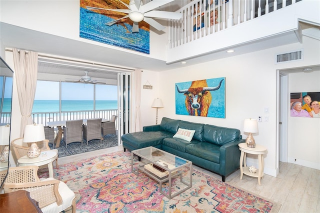 7548 Palm Island Dr S Unit 1724, Placida, FL 33946 - living room with ceiling fan, visible vents, a towering ceiling, wood finished floors, and a water view