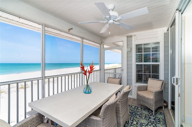 7548 Palm Island Dr S Unit 1724, Placida, FL 33946 - sunroom / solarium with a view of the beach, a ceiling fan, and a water view