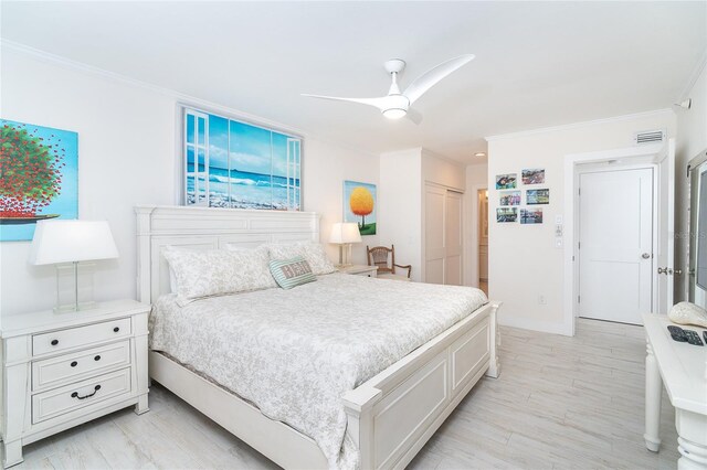 7548 Palm Island Dr S Unit 1724, Placida, FL 33946 - bedroom featuring a closet, visible vents, ornamental molding, and light wood-type flooring