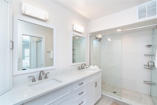 7548 Palm Island Dr S Unit 1724, Placida, FL 33946 - ensuite bathroom with double vanity, visible vents, a sink, and a stall shower