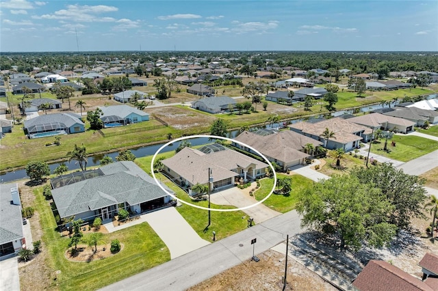 bird's eye view with a water view and a residential view