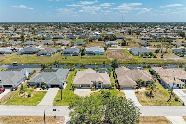bird's eye view featuring a water view and a residential view