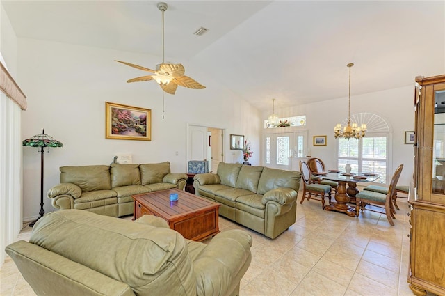 living room with light tile patterned flooring, high vaulted ceiling, visible vents, and ceiling fan with notable chandelier