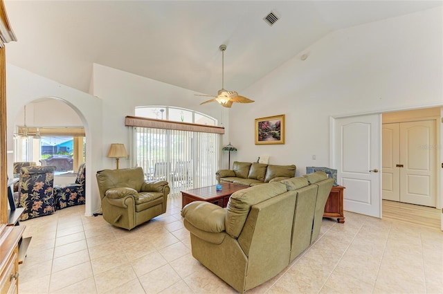 living room with a ceiling fan, visible vents, arched walkways, high vaulted ceiling, and light tile patterned flooring
