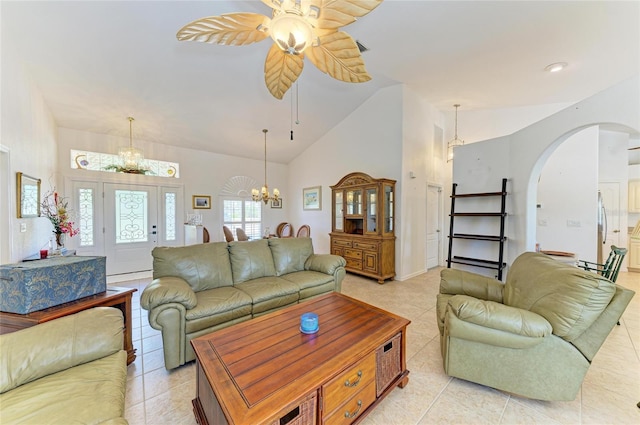 living room with arched walkways, ceiling fan with notable chandelier, light tile patterned flooring, and high vaulted ceiling