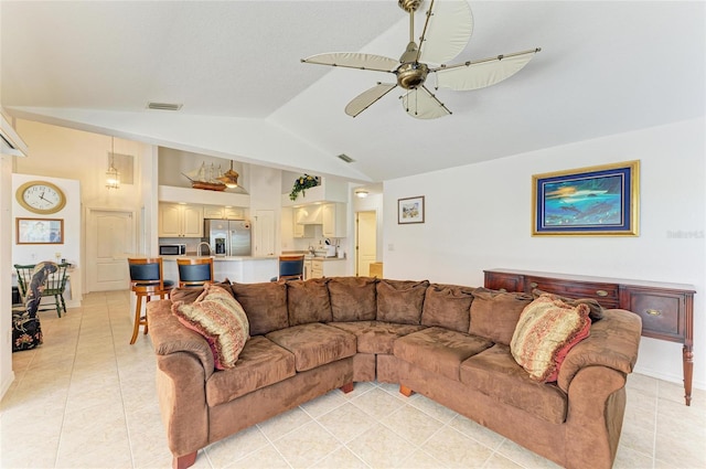 living area with ceiling fan, visible vents, light tile patterned floors, and lofted ceiling