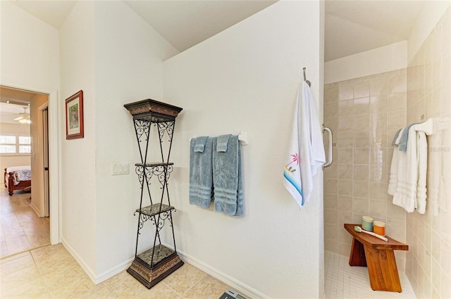full bathroom with ceiling fan, walk in shower, tile patterned floors, baseboards, and ensuite bath