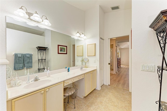 full bath featuring visible vents, a sink, tile patterned flooring, and double vanity