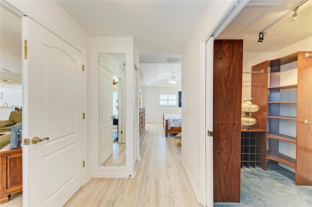 hall featuring baseboards and light wood-type flooring