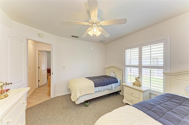 bedroom with visible vents, ceiling fan, and light carpet