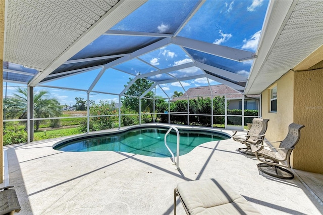 outdoor pool featuring glass enclosure and a patio area