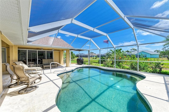 pool featuring a patio and glass enclosure