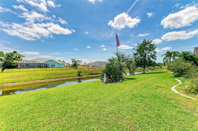 view of yard with a water view and fence