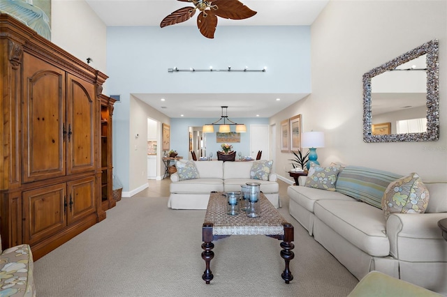 2950 N Beach Rd Unit B324, Englewood, FL 34223 - carpeted living room featuring recessed lighting, baseboards, ceiling fan with notable chandelier, and a towering ceiling