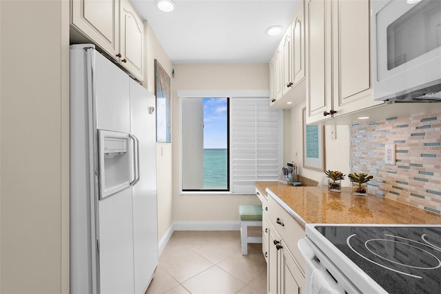 2950 N Beach Rd Unit B324, Englewood, FL 34223 - kitchen featuring tasteful backsplash, baseboards, light tile patterned flooring, recessed lighting, and white appliances