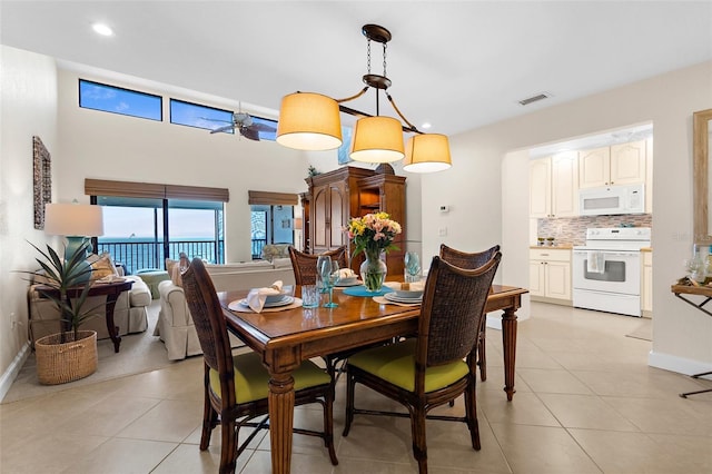 2950 N Beach Rd Unit B324, Englewood, FL 34223 - dining space featuring visible vents, light tile patterned flooring, baseboards, a high ceiling, and recessed lighting