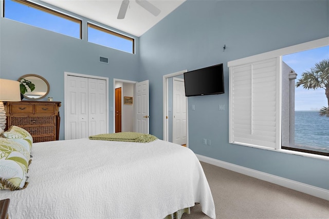 2950 N Beach Rd Unit B324, Englewood, FL 34223 - carpeted bedroom featuring a closet, visible vents, baseboards, high vaulted ceiling, and a ceiling fan