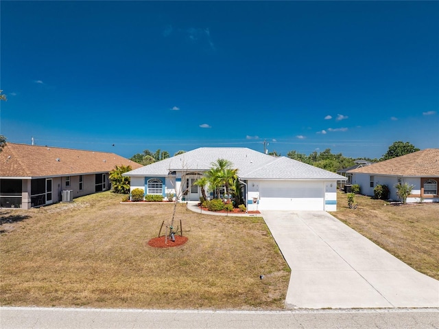 ranch-style house with central air condition unit, driveway, a front yard, and a garage