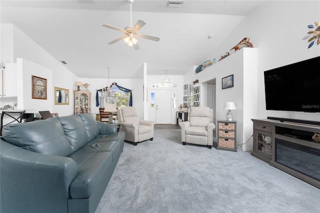 carpeted living area featuring ceiling fan, vaulted ceiling, and visible vents