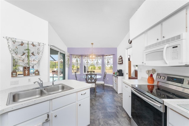 kitchen with a sink, white microwave, vaulted ceiling, and stainless steel range with electric cooktop