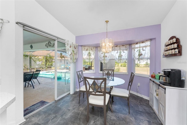 dining area with baseboards, an inviting chandelier, and stone finish floor
