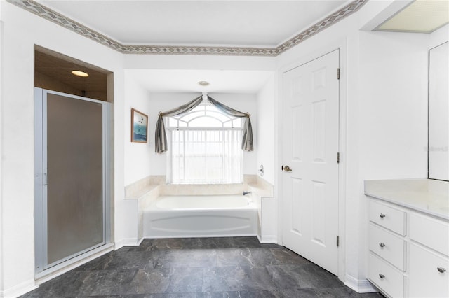 full bathroom with stone finish floor, a garden tub, a shower stall, vanity, and baseboards