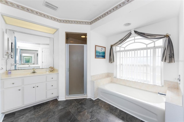 full bathroom featuring vanity, a shower stall, a garden tub, and visible vents