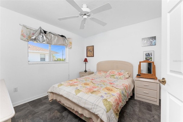 bedroom with baseboards and a ceiling fan