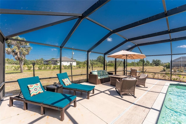 view of patio featuring glass enclosure, an outdoor pool, and an outdoor hangout area